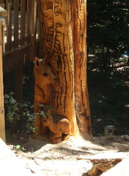 Doe and fawn chainsaw carvings in tree stump